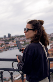 Alessandra posing on a balcony with Lisbon view behind