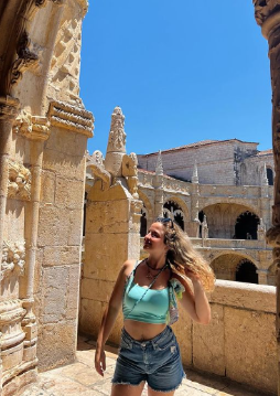 Özge posing in the sun on an old building